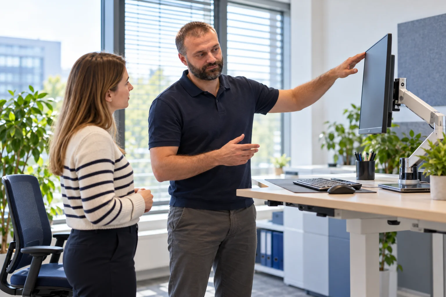 KI-Themenbild: Tobias Schier bespricht die Ergonomie eines Büroarbeitsplatzes